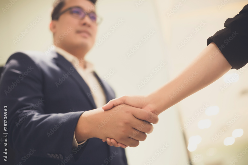 Business people shaking hands, between meeting in seminar room Business people shaking hands, between meeting in seminar room