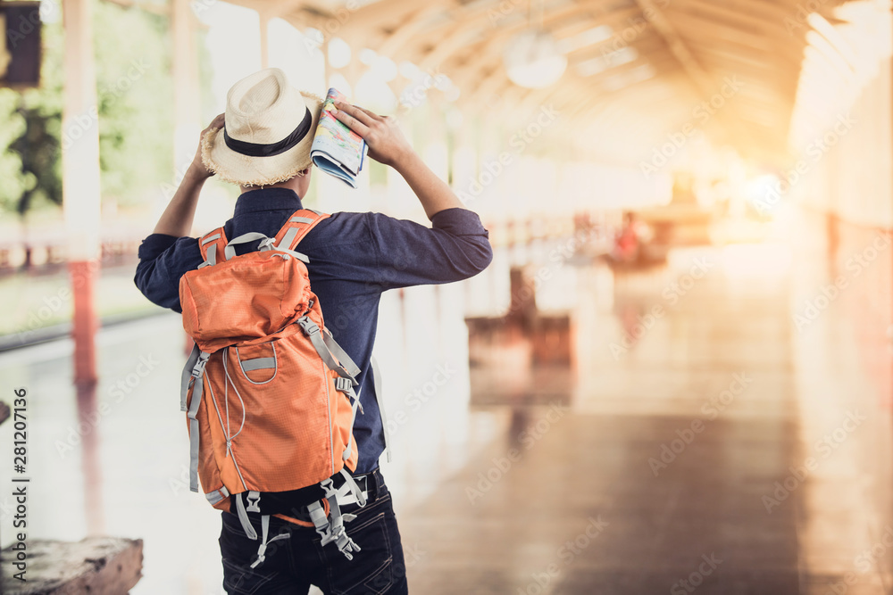 Men are watching the map, waiting for someone,or taxi in the train station.