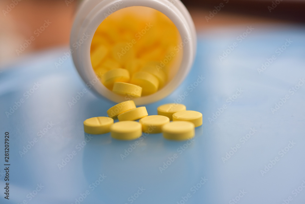 Yellow pills placed on the table Yellow pills placed on the table