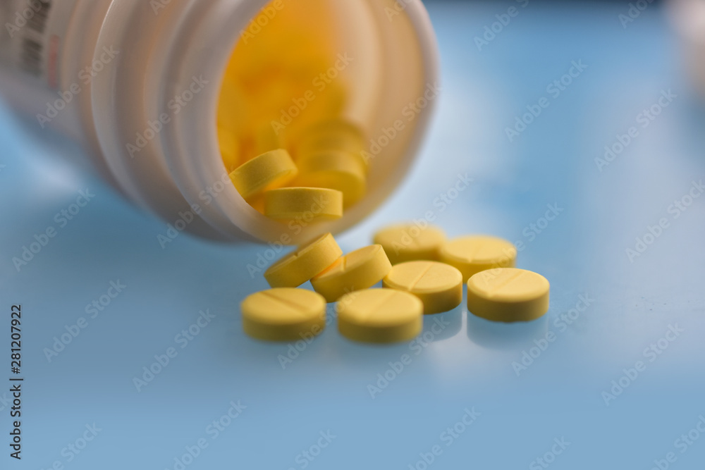 Yellow pills placed on the table Yellow pills placed on the table