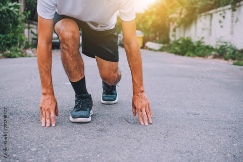 Runners tied in shoes,Man run on the street be running for exercise,Run sports background and closeup at running shoe © Suriyo