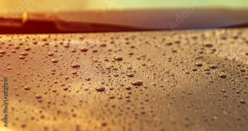Beautiful drops of water on the polished bonnet of a clean car - shallow depth of field - copy space