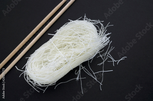 Uncooked Chinese cellophane noodles or glass noodles on black surface