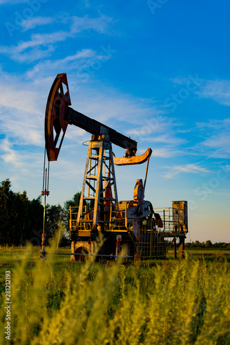 Oil pump. Oil industry equipment in a rape chain. oil pumps in Russia. Oil production.
