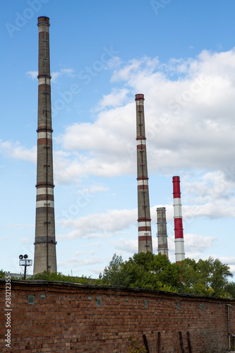 factory chimneys on background of blue sky