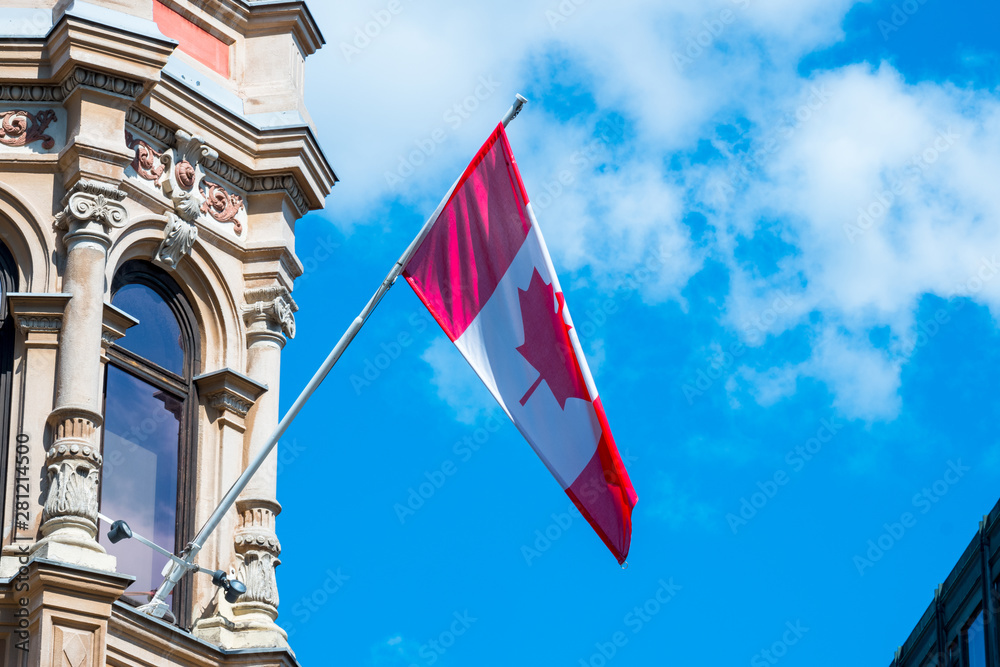 Canada Flag in front of a clear blue sky