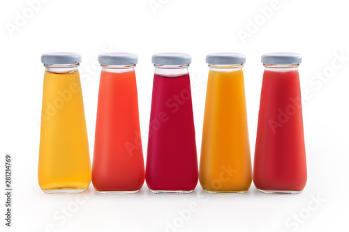 Assorted juices in small glass bottles isolated on white