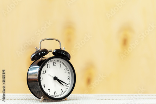 Alarm clock on wooden table close up