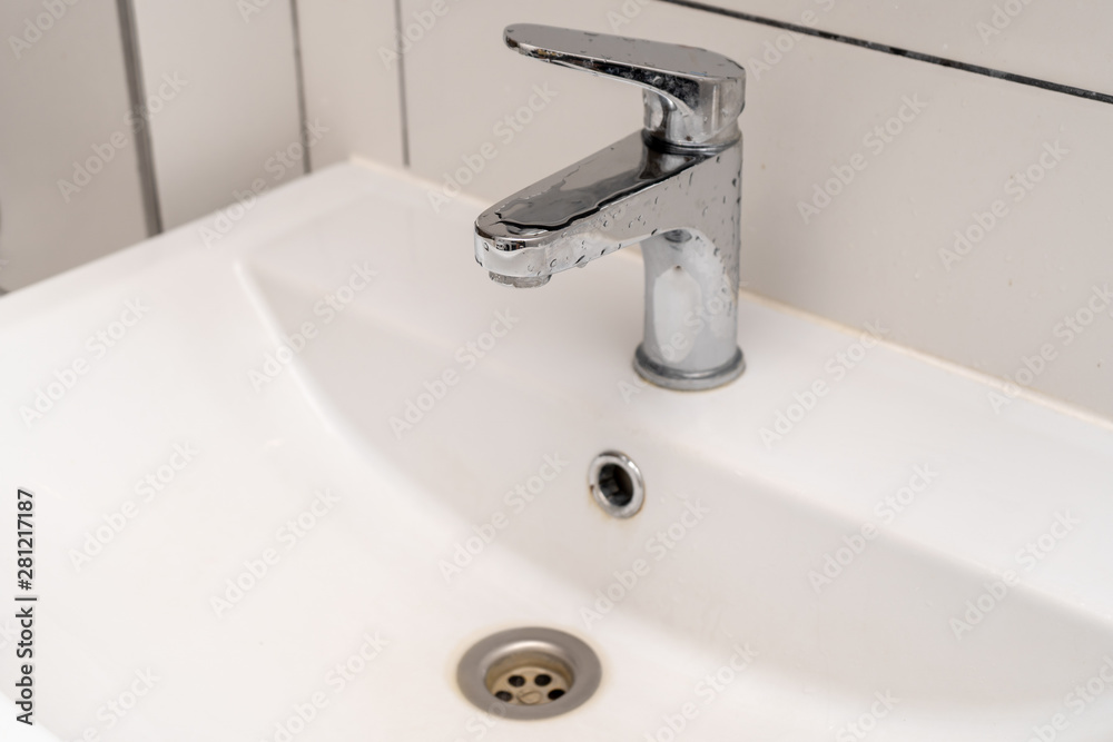 Hand washing. White ceramic sink and bathroom faucet Hand washing. White ceramic sink and bathroom faucet