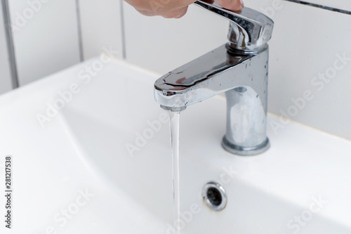 Close-up. Washing hands in the bathroom in the sink. Women's hands close the tap with water