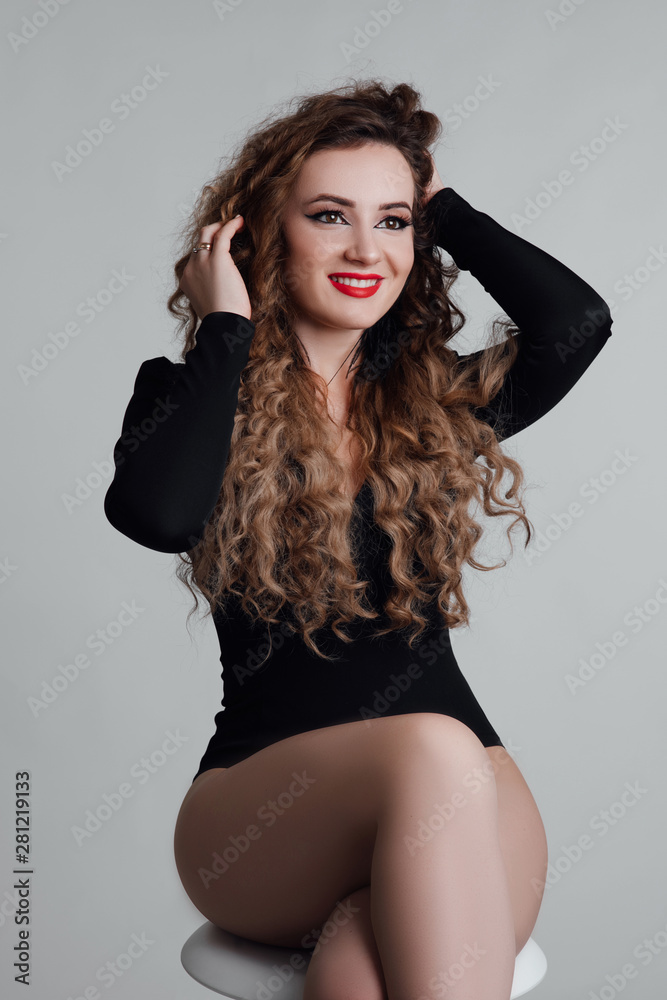 Fototapeta premium Healthy hair. Beautiful young sexy woman with long curly hairstyle. Brunette with professional makeup.