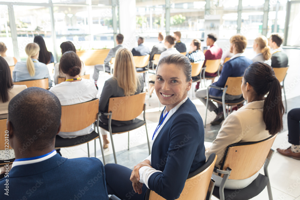 Caucasian female executive sat in conference room, smiling to camera Caucasian female executive sat in conference room, smiling to camera