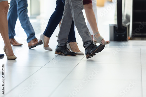 Diverse executives walking in the same direction in hall