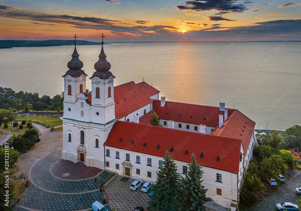 Tihany, Hungary - Aerial skyline view of the famous Benedictine Monastery of Tihany (Tihany Abbey) with beautiful colourful sky and clouds at sunrise over Lake Balaton