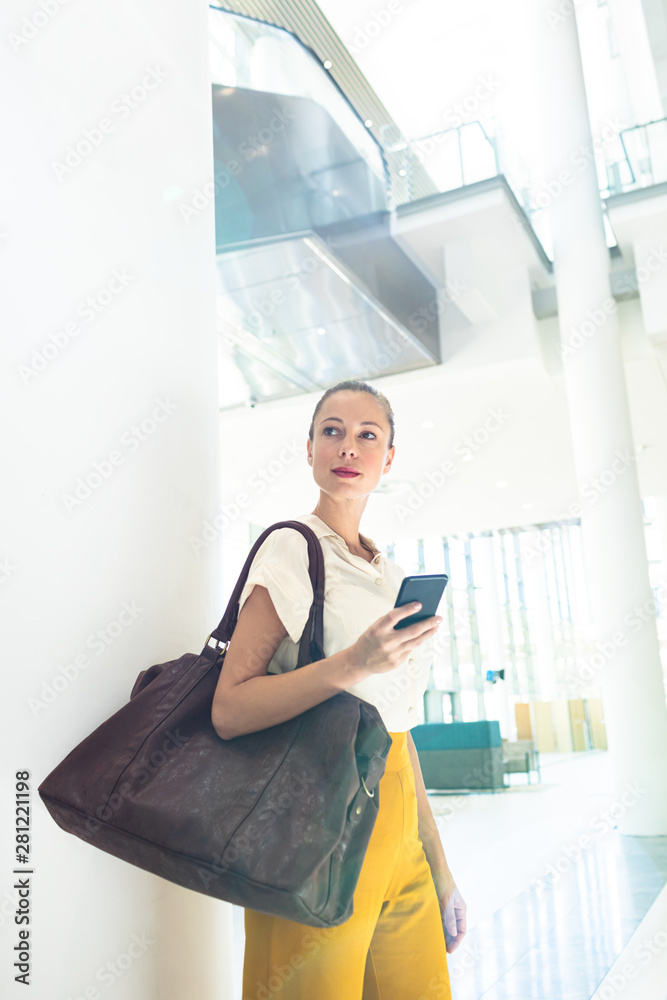 Female executive looking away while standing in modern office