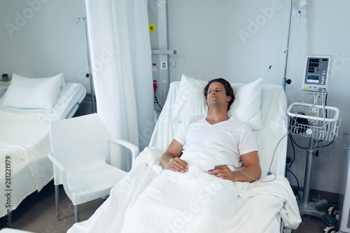 Bild auf Leinwand Male patient relaxing on bed in the ward at hospital