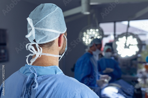 Male surgeon standing in operation room at hospital