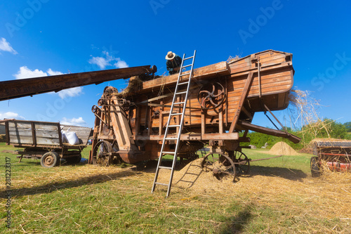 Ancient threshing machine for wheat photo