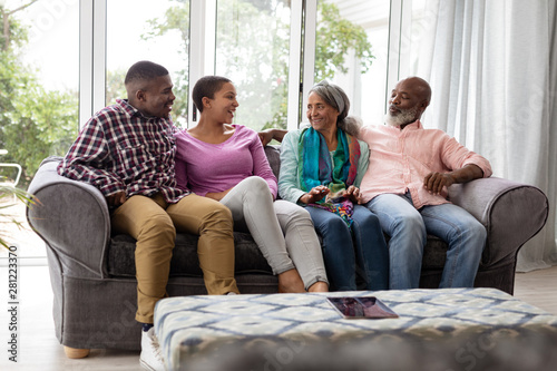 Family interacting with each other on a sofa in living room