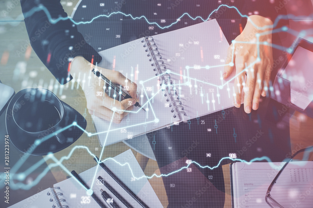 Forex chart hologram on hand taking notes background. Concept of analysis. Multi exposure Forex chart hologram on hand taking notes background. Concept of analysis. Multi exposure