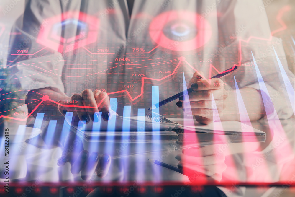 Financial forex graph drawn over hands taking notes background. Concept of research. Double exposure Financial forex graph drawn over hands taking notes background. Concept of research. Double exposure