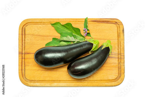 blue eggplant fruit with flower and leaves on a wooden kitchen board on a white background