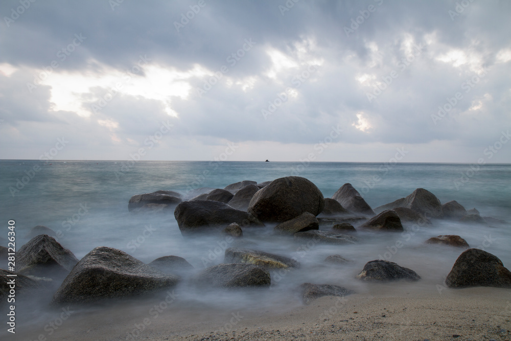 Landscape: Italy, on the beach at sunset rocks on the sea Landscape: Italy, on the beach at sunset rocks on the sea