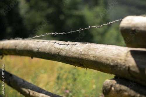 wooden fence with barbed wire.Restriction of freedom. Prohibited