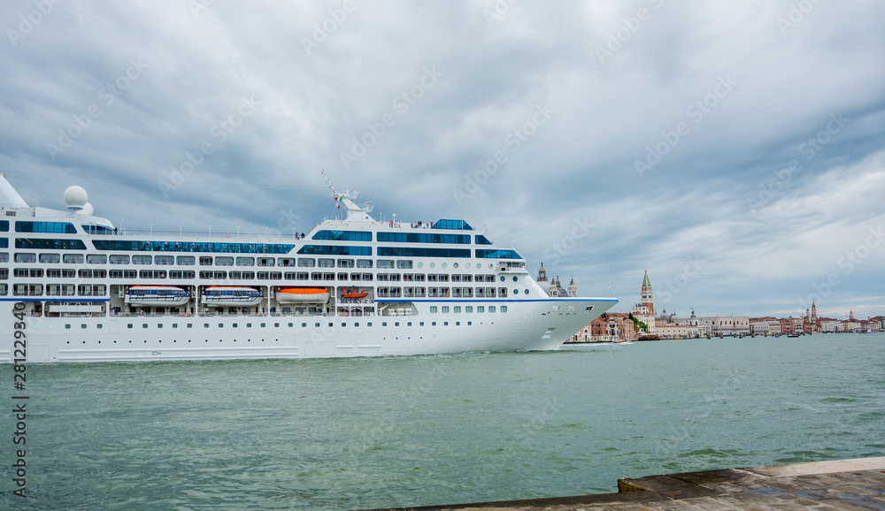 Cruise liner in the Venice lagoon and  the view from the opposite shore of the Venetian Lagoon of the island on San Giorgio Maggiore and the Doge's Palace. Venice, Italy