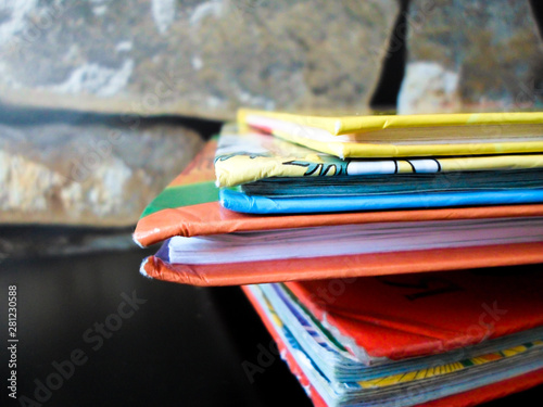 Education and reading concept, back to school - a group of colorful books on a black table