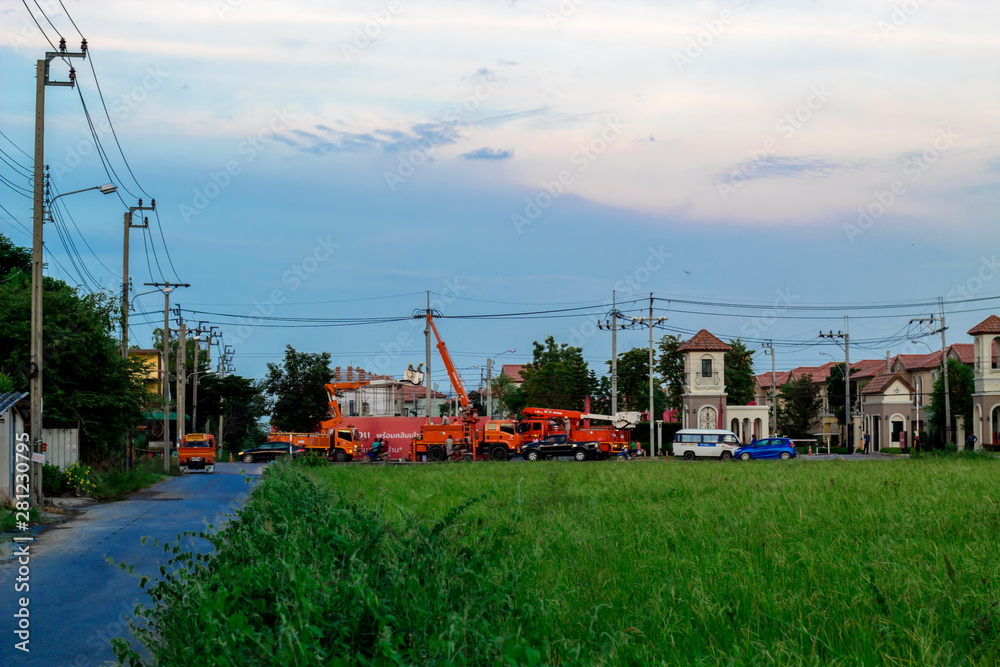 Fototapeta premium Bangkok, Thailand July 29,2019 :Electricity employees are repairing high voltage wires