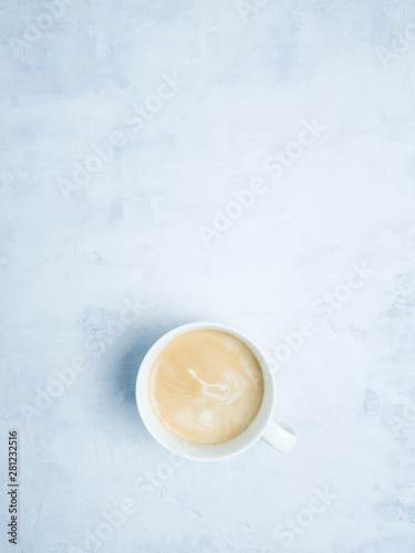 Coffe cup on light blue background. Copy space. Flat lay. 