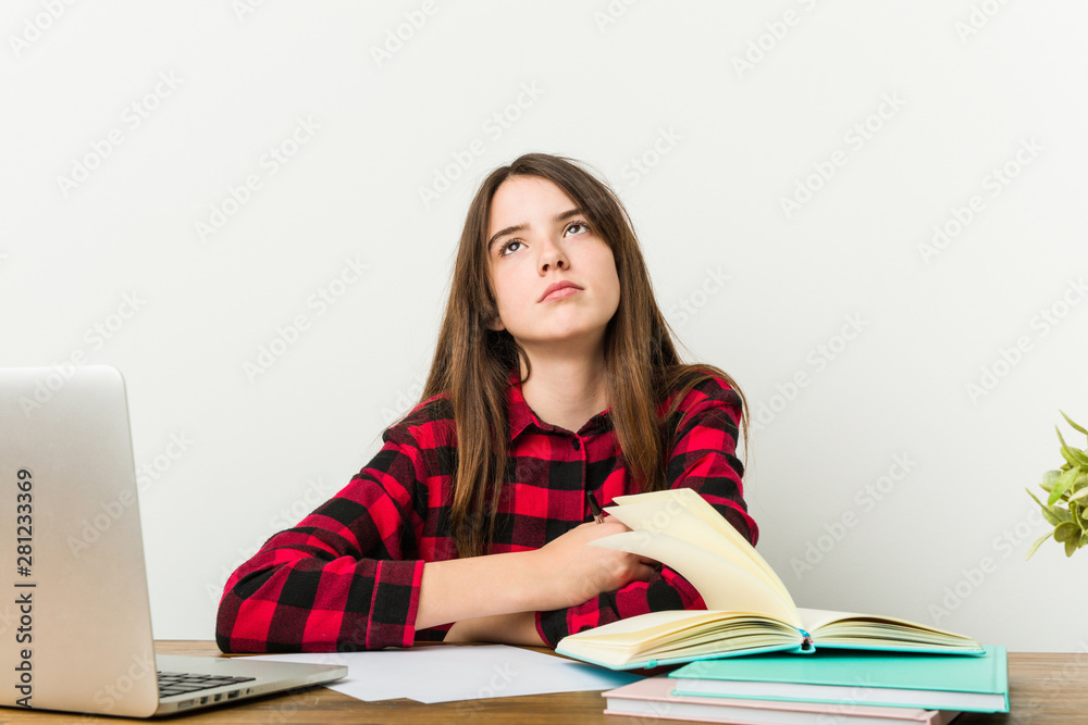 Young teenager going back to her routine doing homeworks tired of a repetitive task. Young teenager going back to her routine doing homeworks tired of a repetitive task.