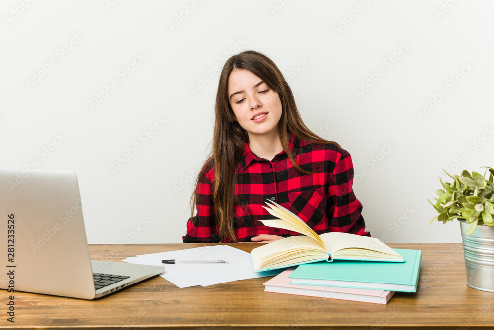 Young teenager going back to her routine doing homeworks sick, suffering from stomachache, painful disease concept. Young teenager going back to her routine doing homeworks sick, suffering from stomachache, painful disease concept.