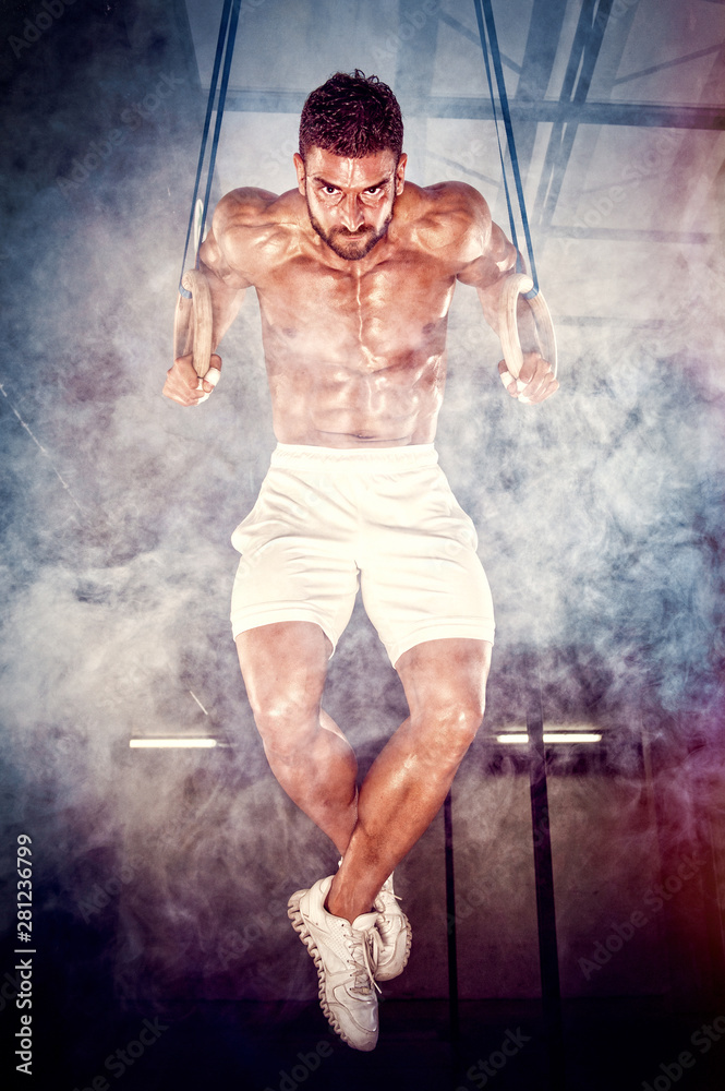 Muscular Men Doing Dips on the Gym Rings
