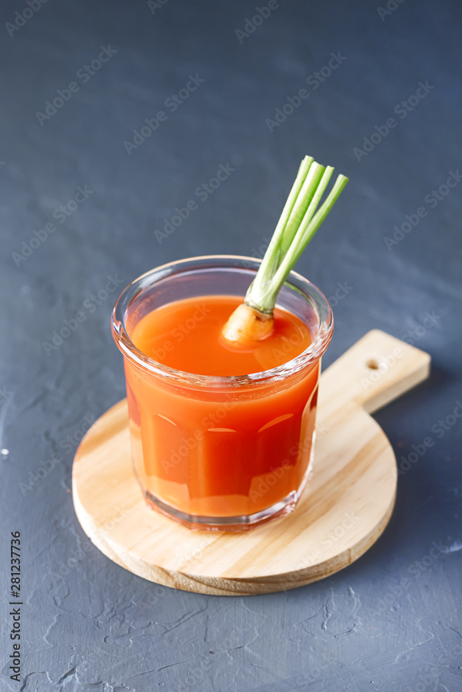 Fresh Carrot Juice in a Glass on a Dark Grey Background Healthy Drink Detox Diet Juice Glass of Tasty Carrot Juice on Wooden Board Vertical Fresh Carrot Juice in a Glass on a Dark Grey Background Healthy Drink Detox Diet Juice Glass of Tasty Carrot Juice on Wooden Board Vertical