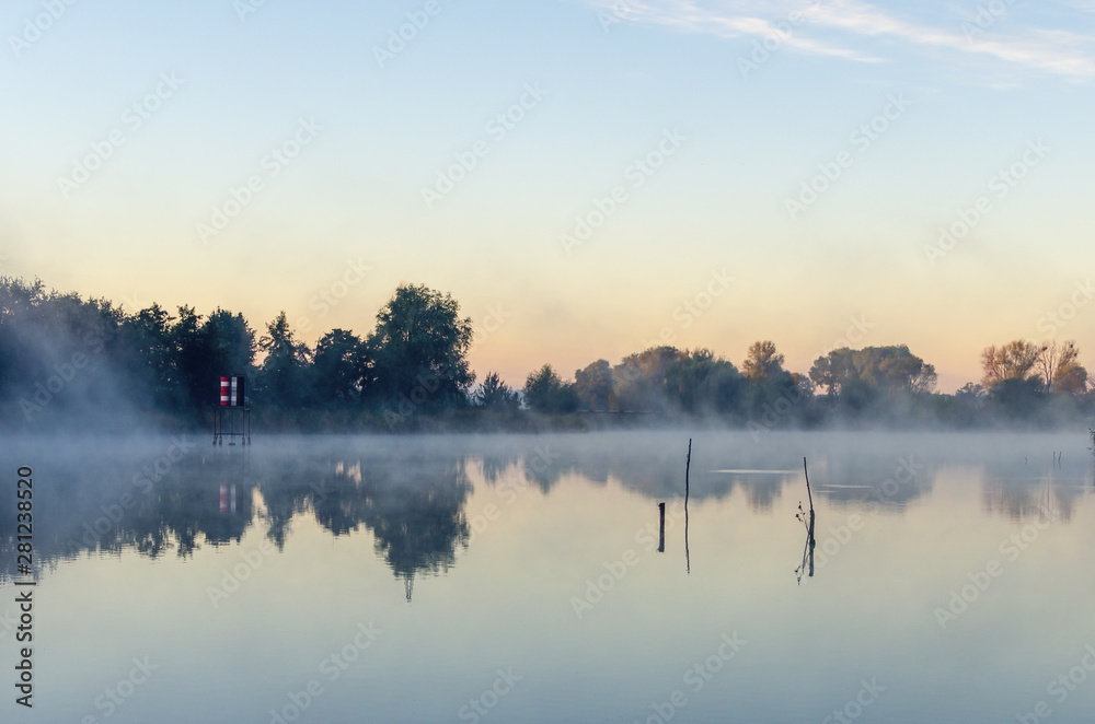 Fototapeta premium Morning landscape with fog over the lake