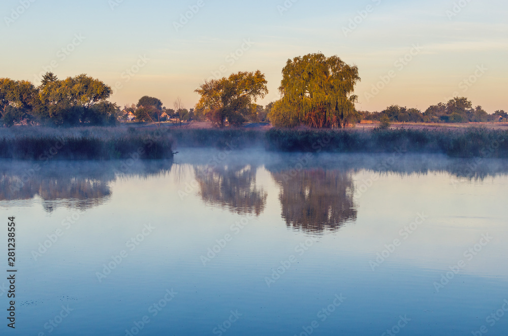 Morning landscape with fog over the lake
