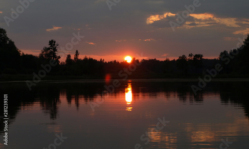 beautiful sun set on calm lake, red sun, calm lake, quiet evening, Latvia