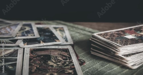 BRUVOLL, NORWAY - MARCH 23, 2011: Occult mystic tarot deck and old tarot cards laying on table for a magical pagan ritual psychic destiny reading - Concept of supernatural, witchcraft or destiny