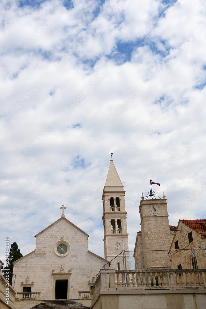Historic parish Church of Mary's Annunciation and clock tower Leroj in Supetar, island Brac, Croatia.