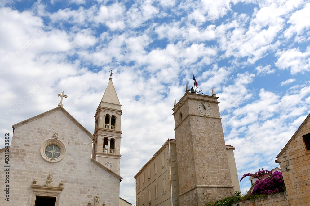 Historic parish Church of Mary's Annunciation and clock tower Leroj in Supetar, island Brac, Croatia.