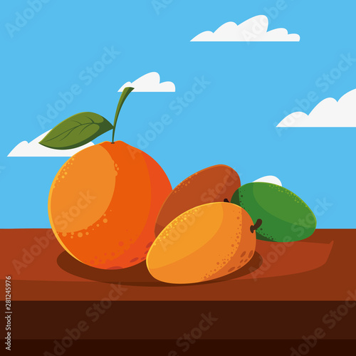 fresh fruit mango and orange on table outdoors