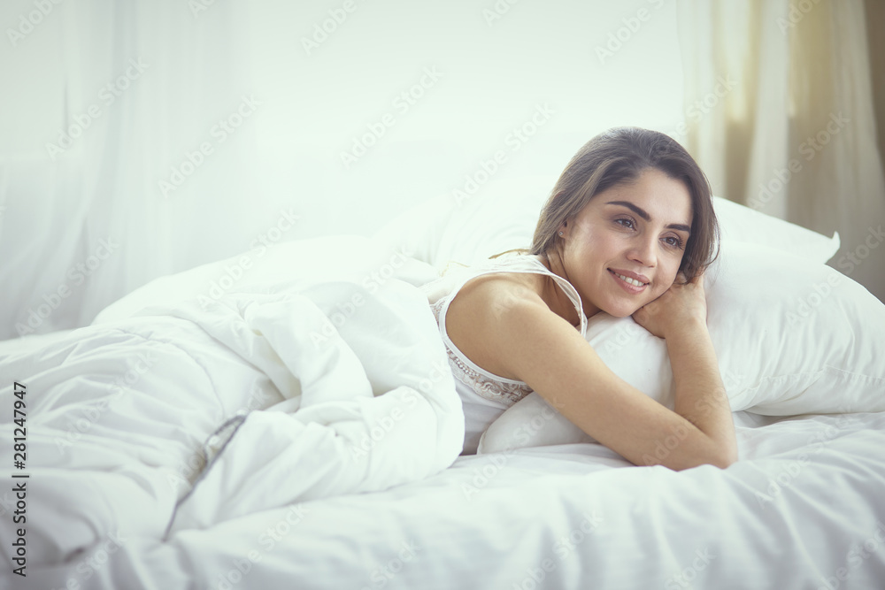 beautiful young woman basking in bed in the morning. Beautiful beautiful young woman basking in bed in the morning. Beautiful