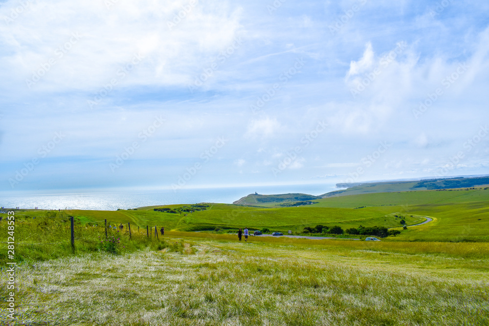 Seven Sisters National Park landscape with green fields and blue ocean in Sussex, UK