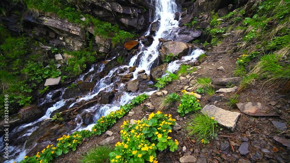 mountain waterfalls. view of giant waterfall flowing in mountains. mountain waterfalls. view of giant waterfall flowing in mountains.