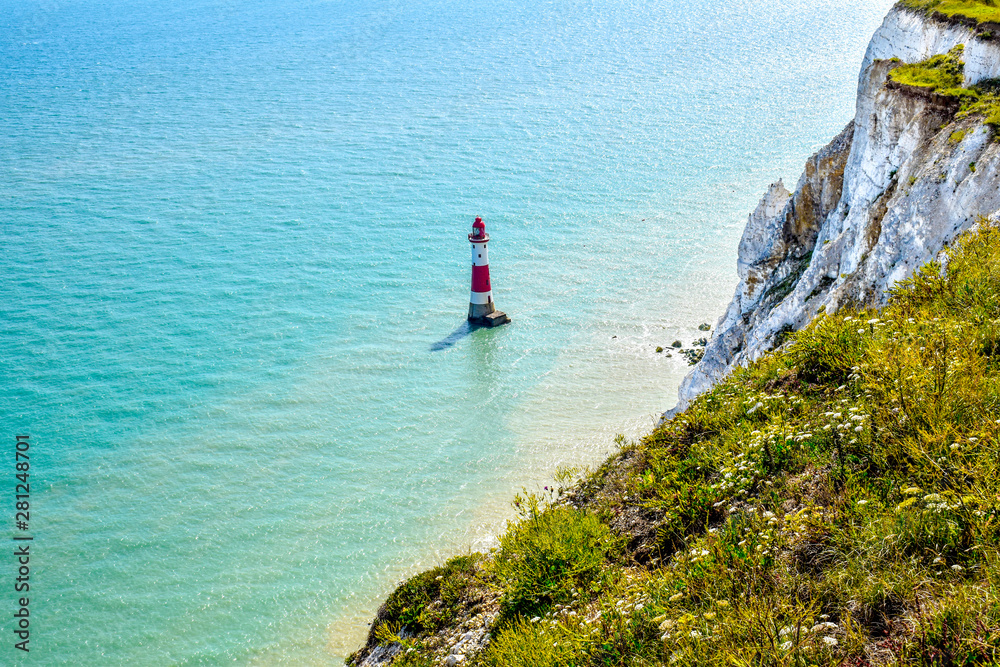 Fototapeta premium Lighthouse, white cliffs and blue sea at Beachy Head in Sussex, England
