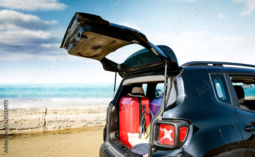 Black summer car on beautiful sunny beach. Summer journey and stopover on the beach.