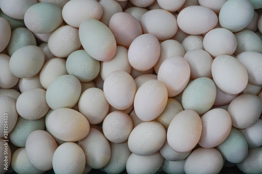 Fresh dirty duck eggs from farm for wholesale at egg market,top view pattern background Fresh dirty duck eggs from farm for wholesale at egg market,top view pattern background