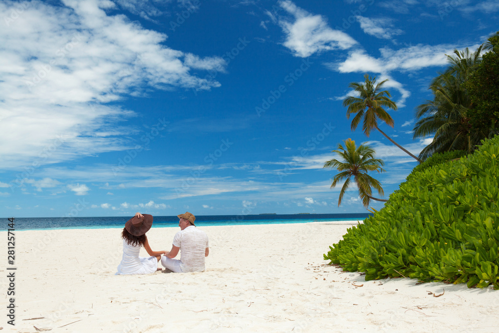 Happy honeymoon vacation at summer. Couple relax on the white sand of beach. Happy sea lifestyle. Young family, man and woman rest on the beach of ocean. Couple in love travel to island. Love travel Happy honeymoon vacation at summer. Couple relax on the white sand of beach. Happy sea lifestyle. Young family, man and woman rest on the beach of ocean. Couple in love travel to island. Love travel